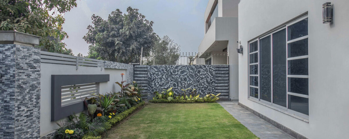 Modern villa exterior with a landscaped lawn in Dubai, photographed by IBN Films.