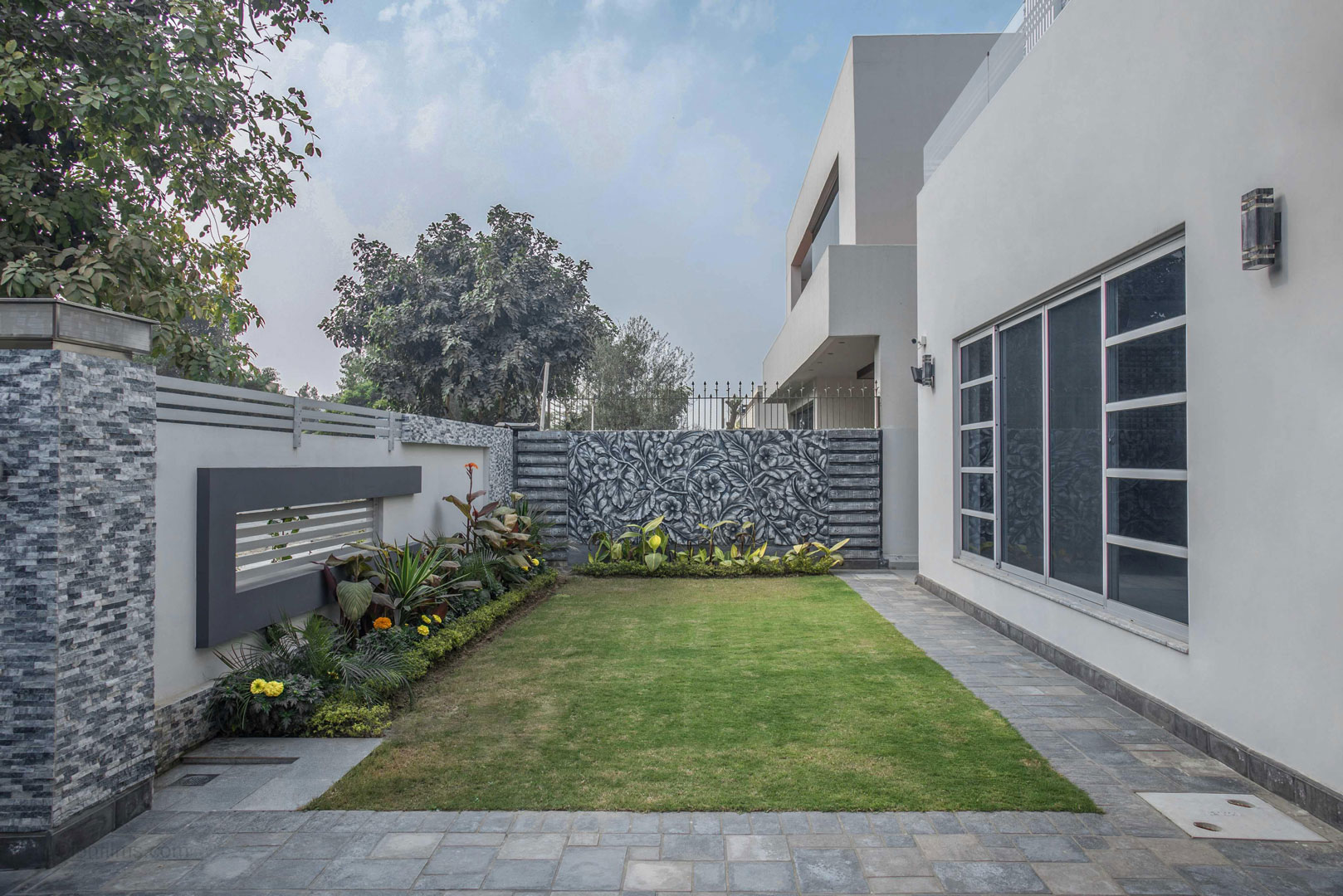Modern villa exterior with a landscaped lawn in Dubai, photographed by IBN Films.