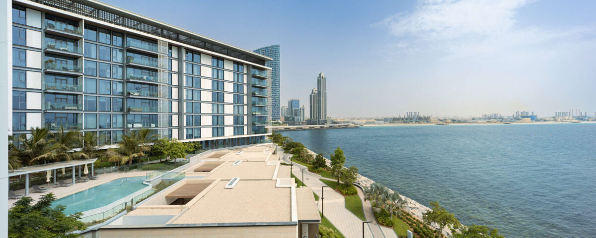 Modern high-rise buildings in Dubai by the beach, photographed by IBN Films.