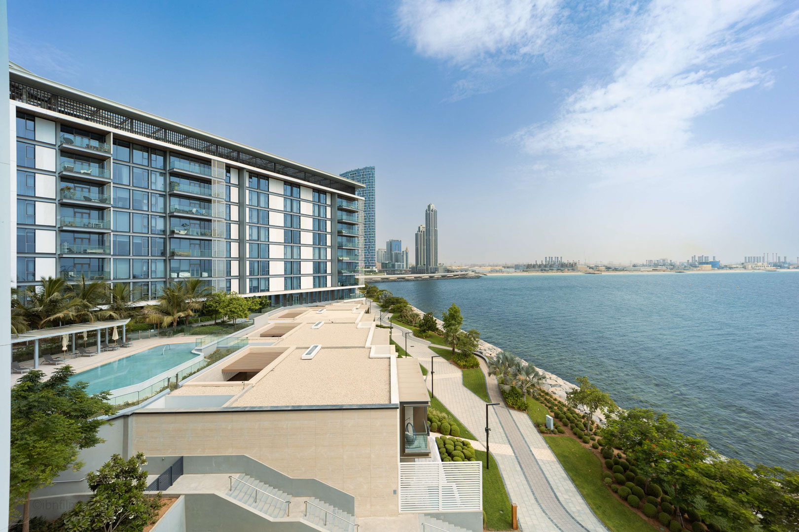 Modern high-rise buildings in Dubai by the beach, photographed by IBN Films.