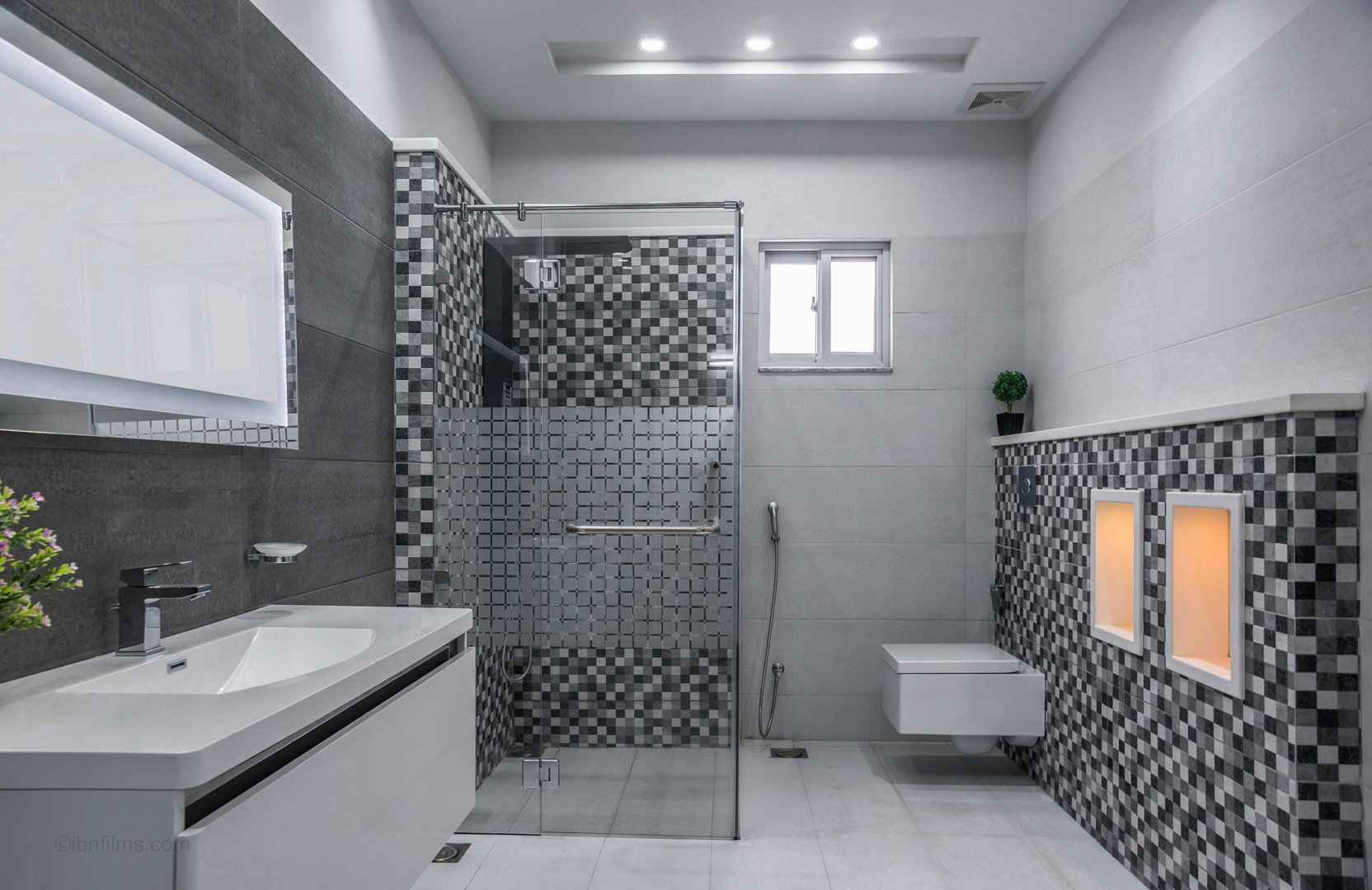 Modern bathroom in Dubai with a glass shower enclosure, photographed by IBN Films.