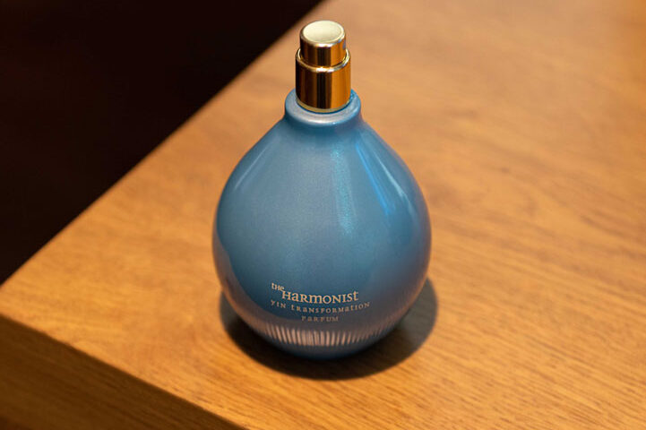 Professional studio product photography of a blue glass bottle with a decorative stopper by IBN FILMS.