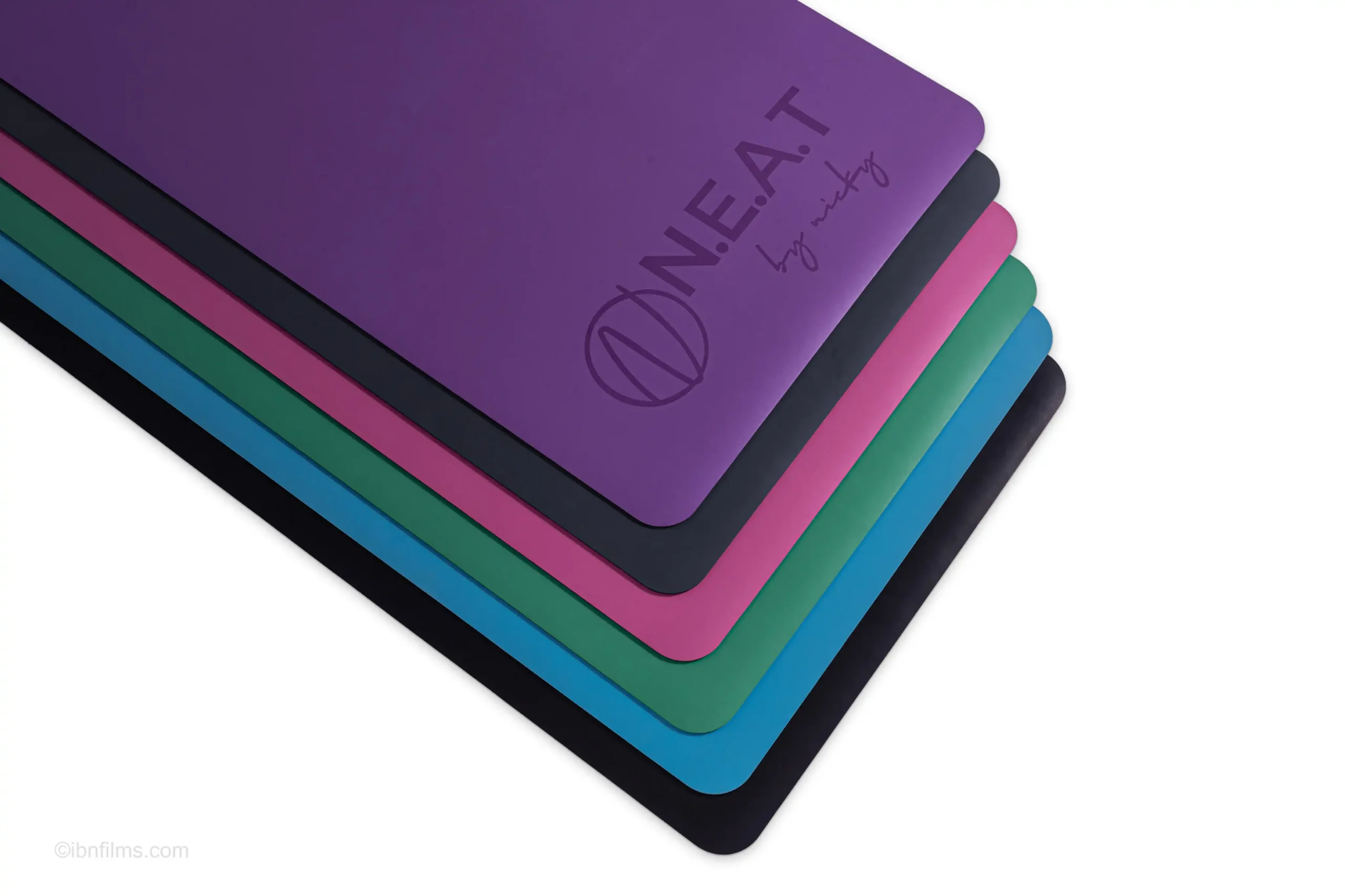 Colorful neat yoga mats stack professional photography by IBNFilms