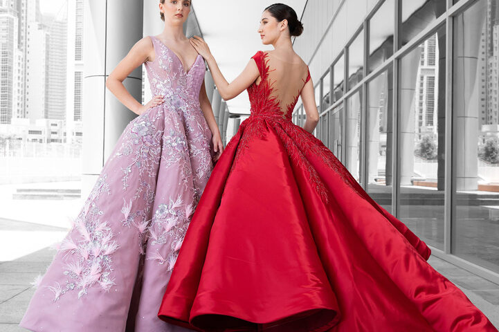 Evening gown fashion photography in Dubai UAE featuring two models wearing red and purple dresses