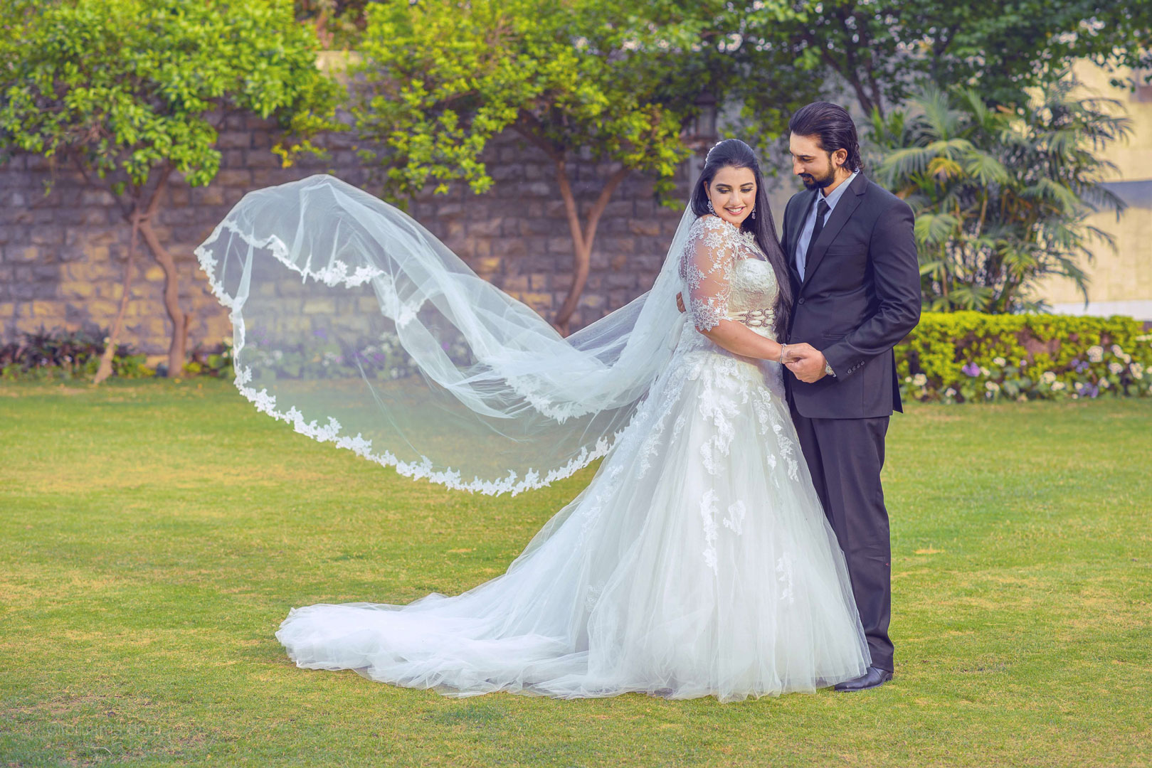 Outdoor wedding photography capturing a romantic wedding moment in a beautiful Dubai setting.