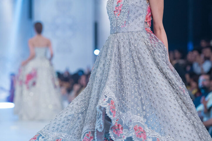 Model presenting a pastel designer outfit on the runway during a fashion show in Dubai, photographed by IBN Films